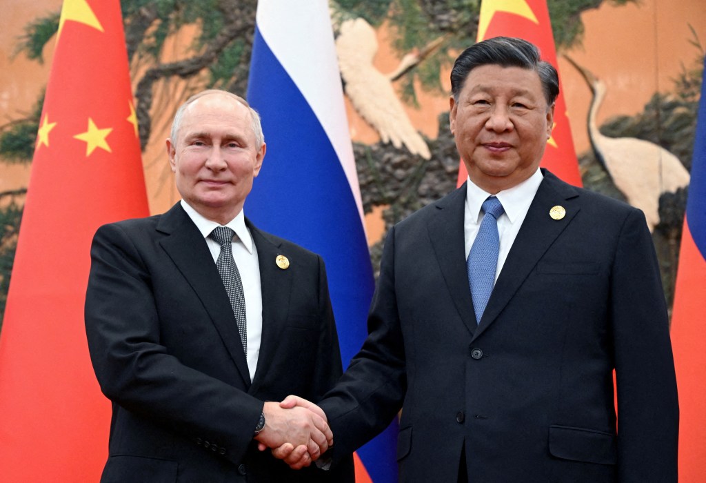 Russian President Vladimir Putin and Chinese President Xi Jinping shake hands during a meeting in Beijing on Oct. 18, 2023.