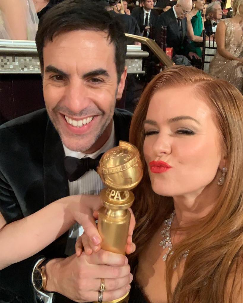 Sacha Baron Cohen smiling with Isla Fisher. 