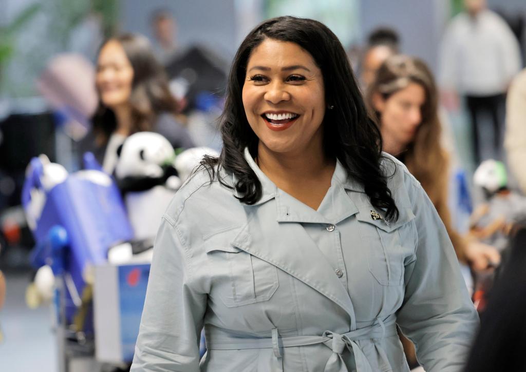 San Francisco Mayor London Breed smiles with several panda dolls on her bag as she arrives at San Francisco International Airport on Aprill 21, 2024.