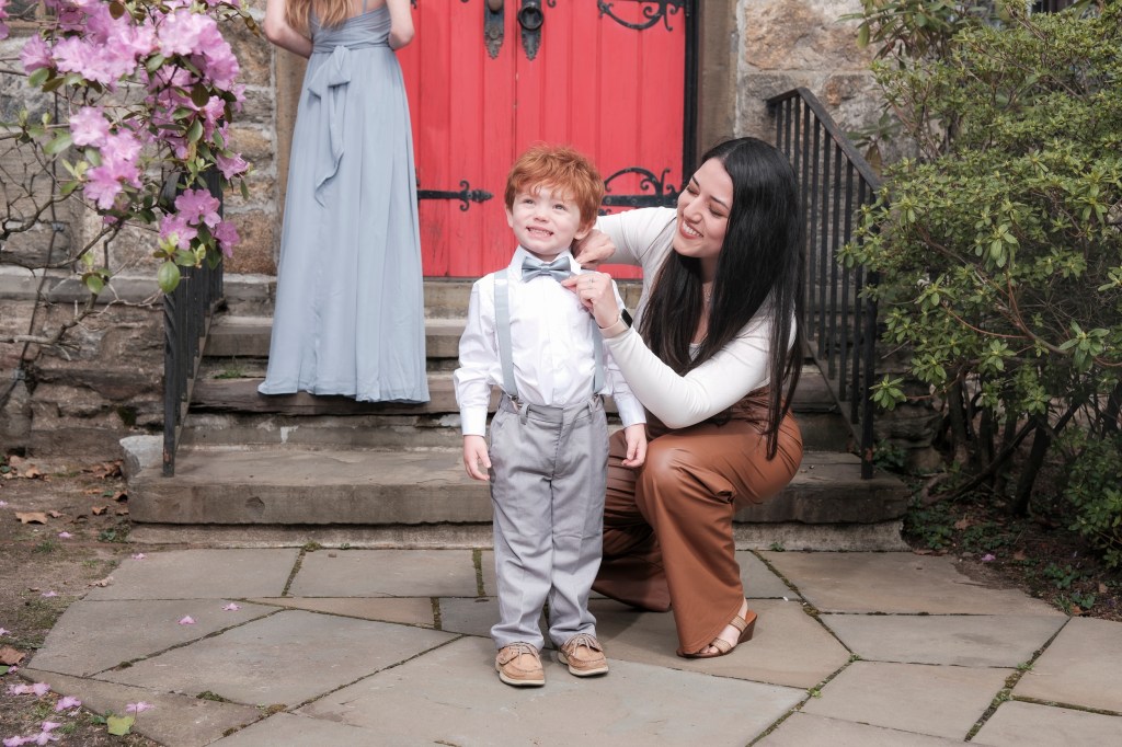 Sandra Weir, a wedding nanny from Yonkers, with redheaded boy at wedding. 