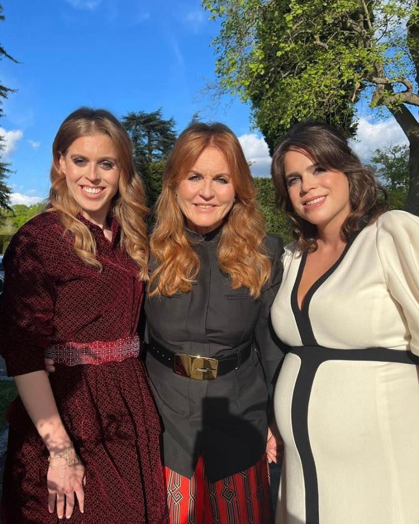 Sarah Ferguson posing with her daughters, Princess Beatrice and Princess Eugenie, at a Coronation concert