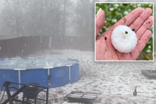 A screenshot capturing a damaging hailstorm in Rock Hill, South Carolina on April 20, 2024 with a hand holding a piece of hailstone