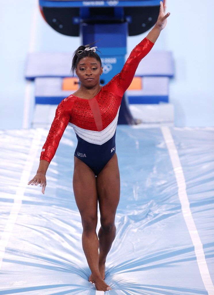 Simone Biles reacts after stumbling on her landing while competing on vault during the Women's Team Final on day four of the Tokyo 2020 Olympic Games.