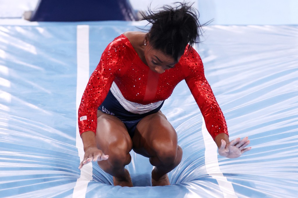 Simone Biles stumbles upon landing after competing in vault during the Women's Team Final on day four of the Tokyo 2020 Olympic Games.