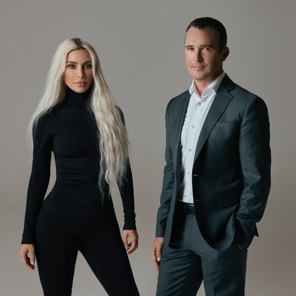 Kim Kardashian and Jay Sammons posing together for a picture to introduce their private equity firm, SKKY Partners