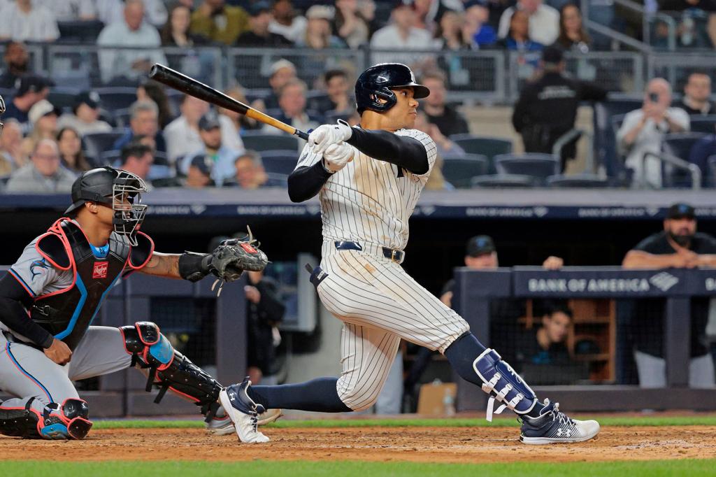 New York Yankees right fielder Juan Soto #22 hits an RBI single driving home New York Yankees third baseman Jon Berti #19 during the sixth inning.