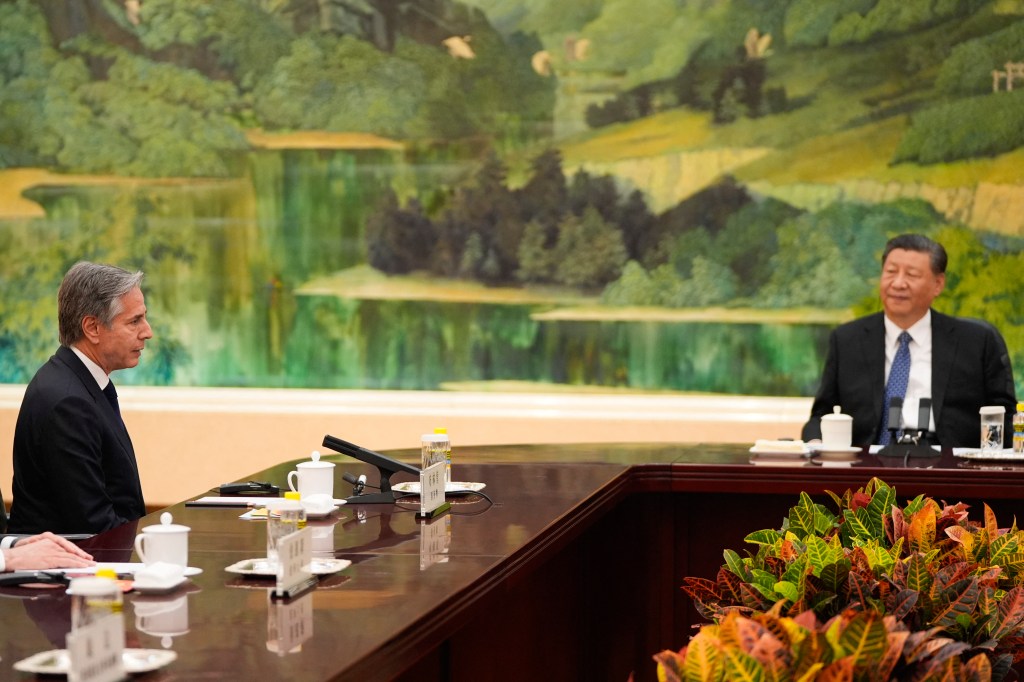 Blinken and Xi sit across from eachother during a meeting in the Great Hall of the People on April 26.