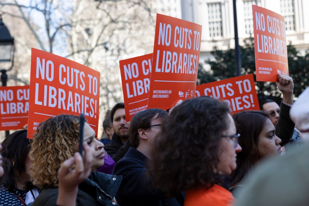 Protesters with red signs.