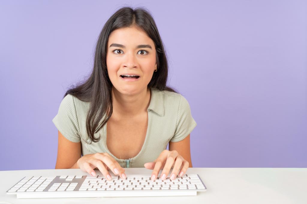 Stressed Gen Z employee at her computer. 