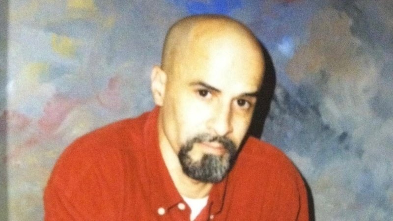 A photo of Eddie Matos, bald, with a goatee, staring into the camera