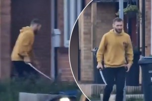 A man in a yellow hoodie holding the terrifying-looking weapon around 7 a.m. while walking through a street near Hainault Tube station in north-east London.