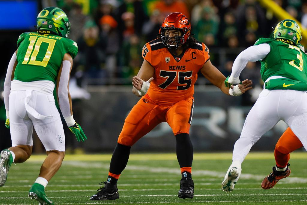 Taliese Fuaga #75 of the Oregon State Beavers blocks during a game against the Oregon Ducks at Autzen Stadium on November 24, 2023 in Eugene, Oregon. 