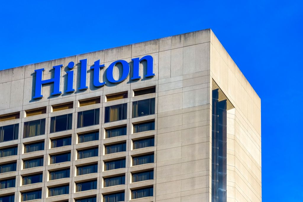 Top portion of a Hilton hotel building with glass windows in Toronto, Canada