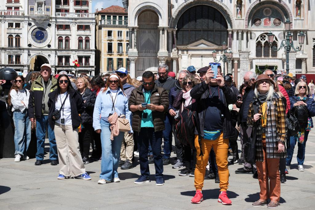 Tourists crowding St. Mark's Square in Venice, Italy after the implementation of a new fee for day trippers