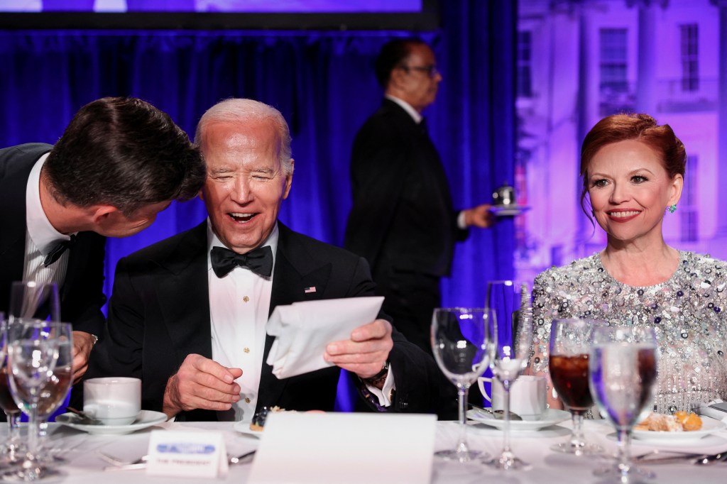 Biden laughs as Jost leans in during Saturday night's dinner.