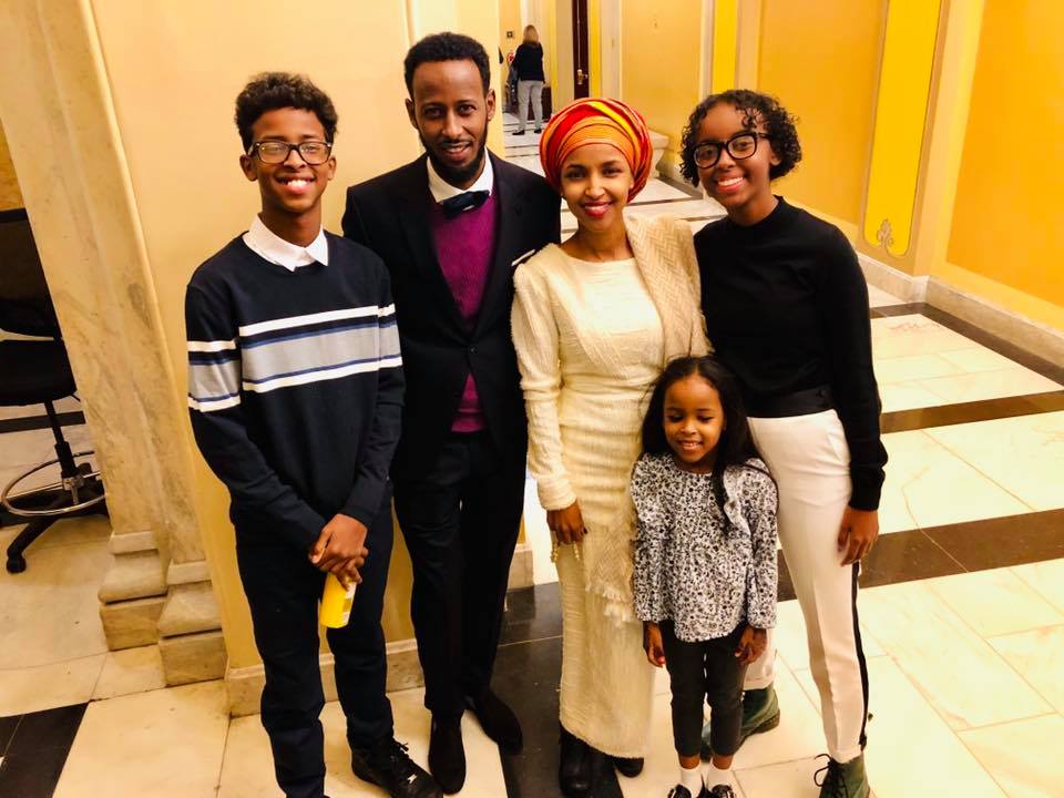 Isra Hirsi (right), her mother and their family smile for a group photo