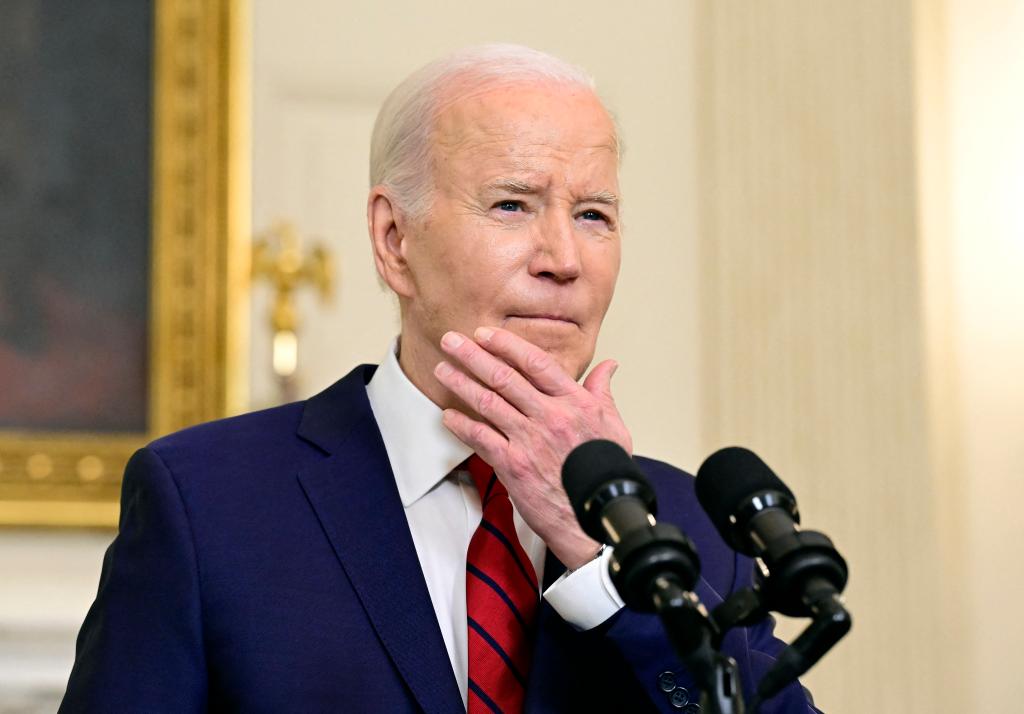 President Joe Biden in a suit and tie, departing after signing the $95 billion National Security Package in the State Dining Room of the White House