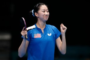 US table tennis player Amy Wu Wang triumphantly raising her racket after winning the gold medal at the Pan American Games Santiago 2023