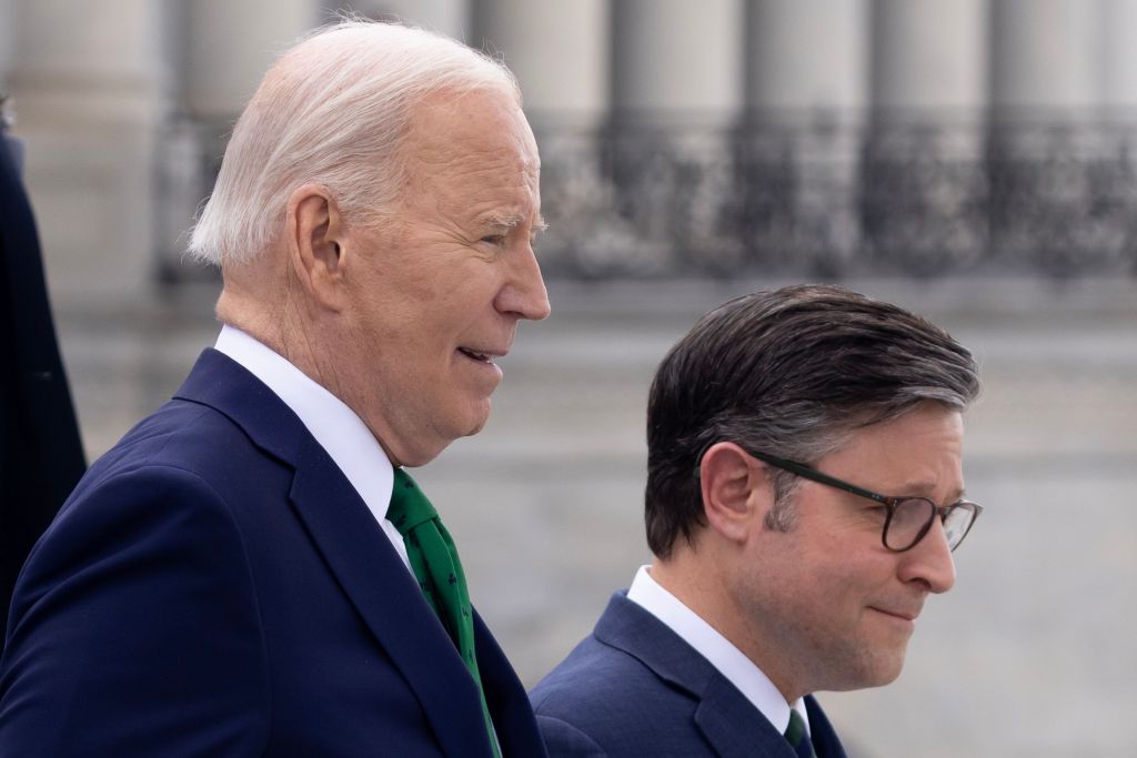 US President Joe Biden (L) and US Speaker of the House Mike Johnson (R) walk down the East Front House steps of the US Capitol following the Friends of Ireland luncheon in Washington, DC.