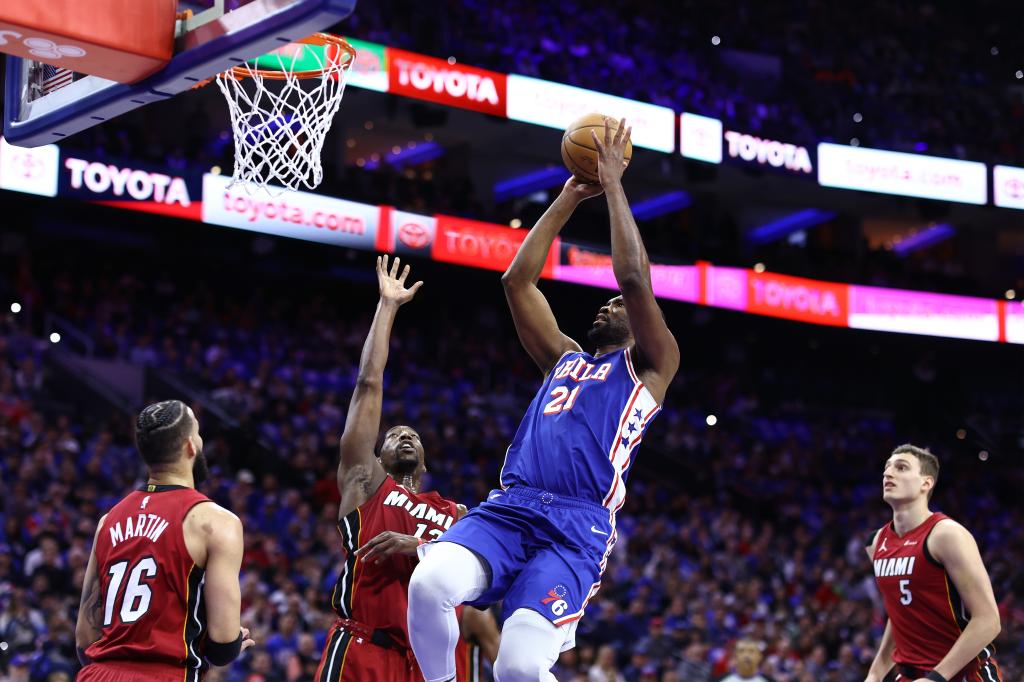 Joel Embiid of the Philadelphia 76ers shoots over Bam Adebayo of the Miami Heat on Wednesday night. 