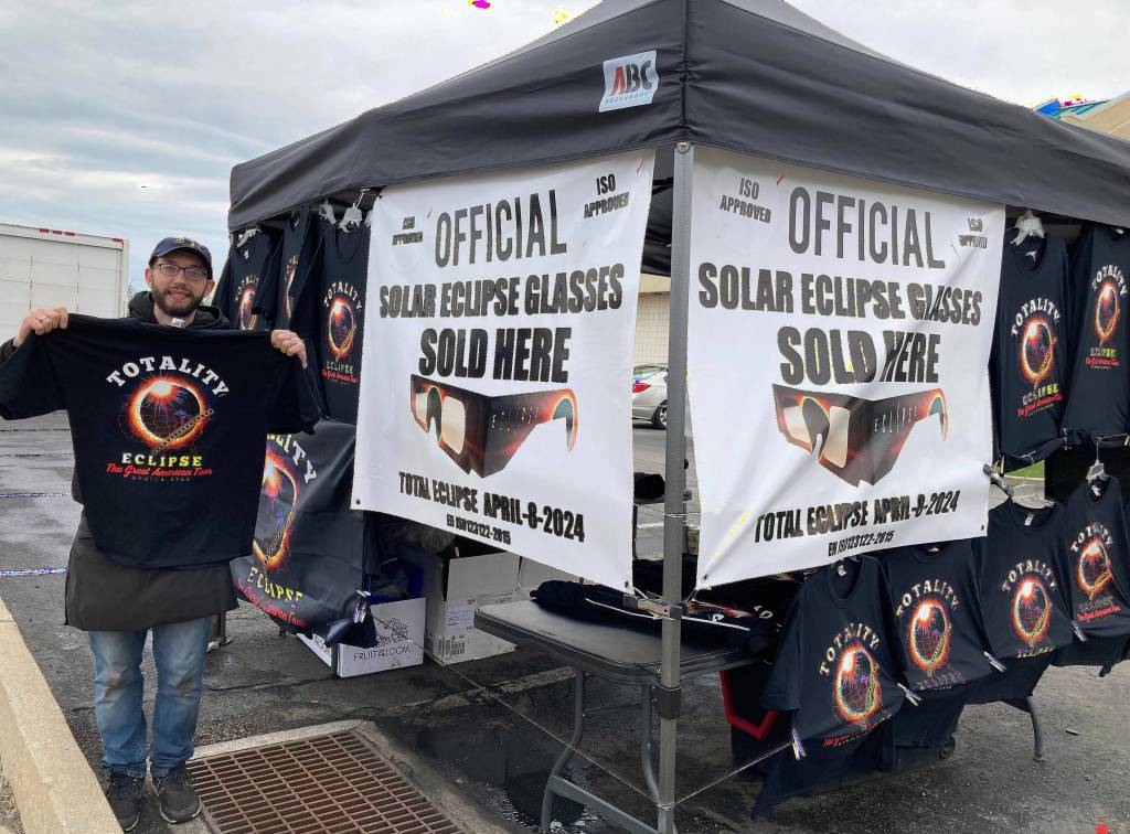 A stand selling eclipse glasses and merchandise in Erie.