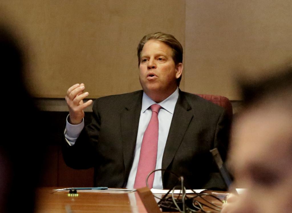 Vice President of ESPN, Norby Williamson, holding a staff meeting in the executive conference room at ESPN Headquarters