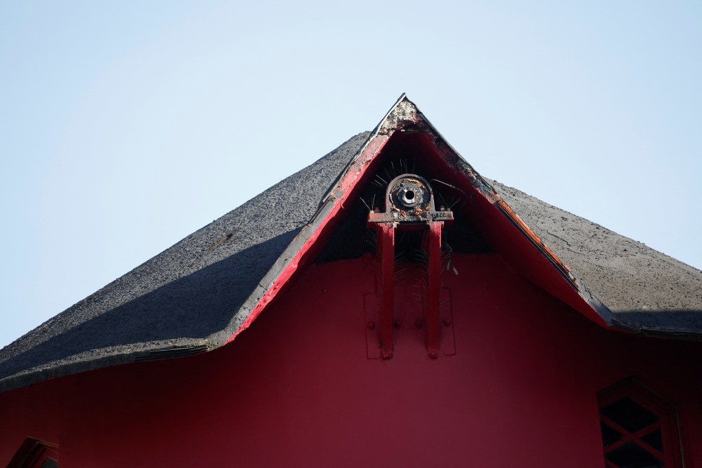 The top of the red windmill without its sails on April 25, 2024.