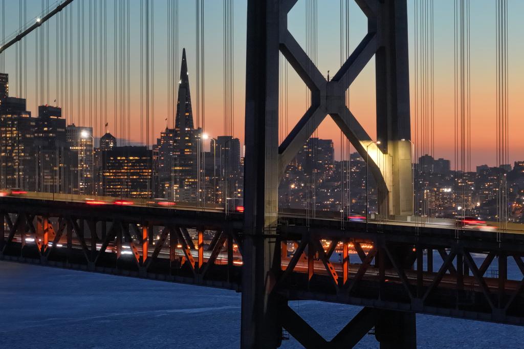 Sunset view of the San Francisco-Oakland Bay Bridge with the city skyline in the background