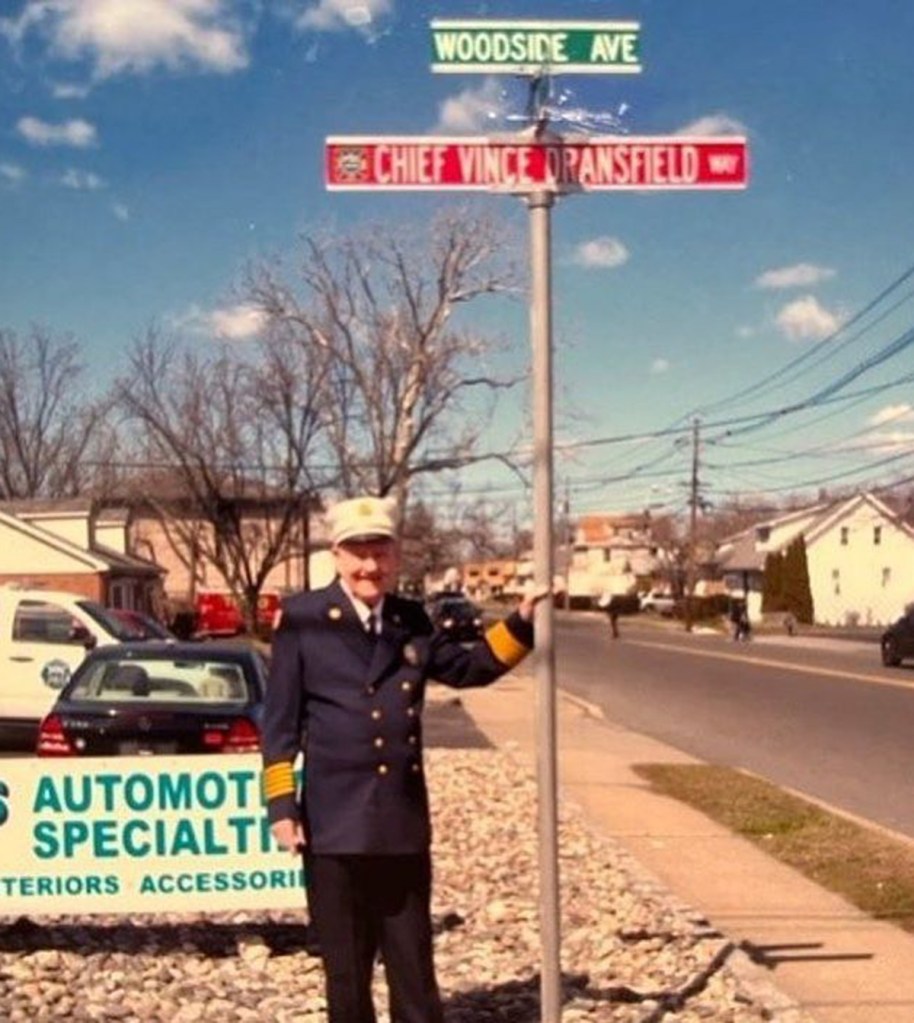 Dransfield poses with a street sign named in his honor.