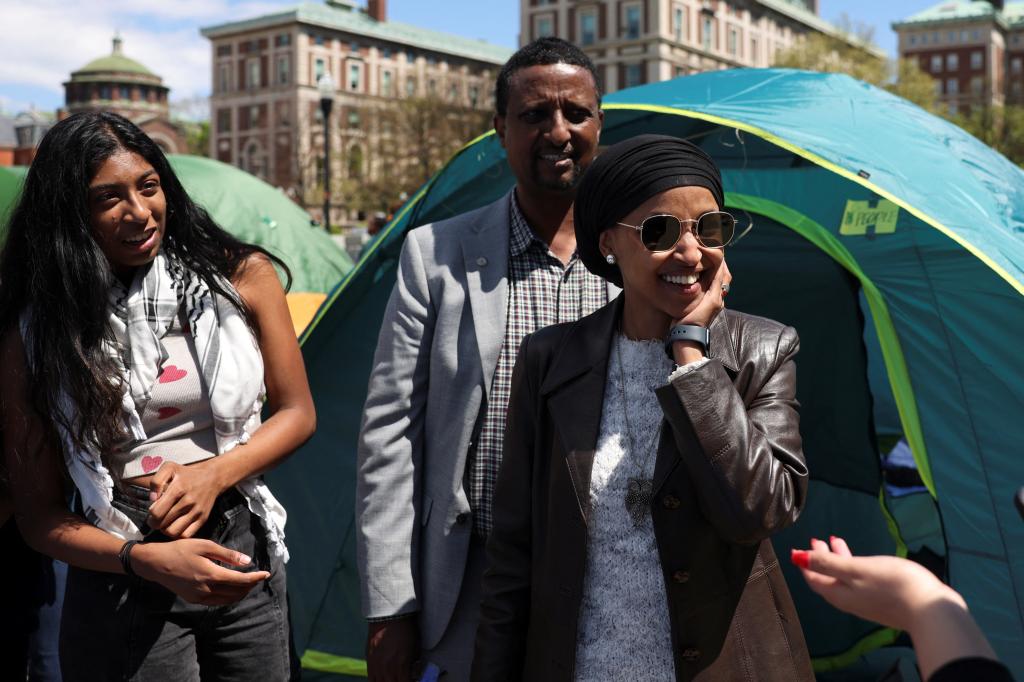 U.S. Democratic House Representative Ilhan Omar visiting a student protest encampment at Columbia University, with a group of people standing in front of tents