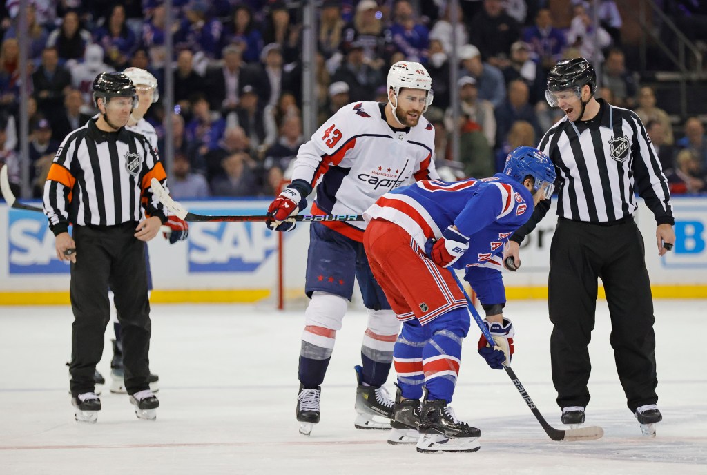 Washington Capitals right wing Tom Wilson  exchanges words with New York Rangers left wing Will Cuylle  during the second period. 