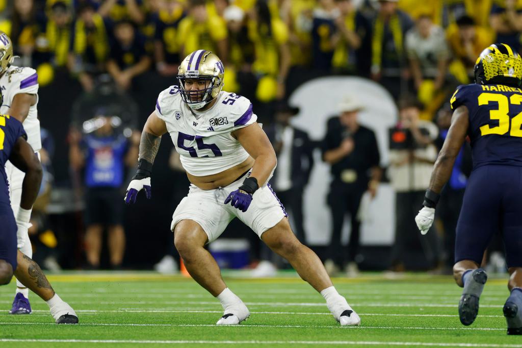 Washington Huskies offensive lineman Troy Fautanu (55) blocks during the CFP National Championship against the Michigan Wolverines