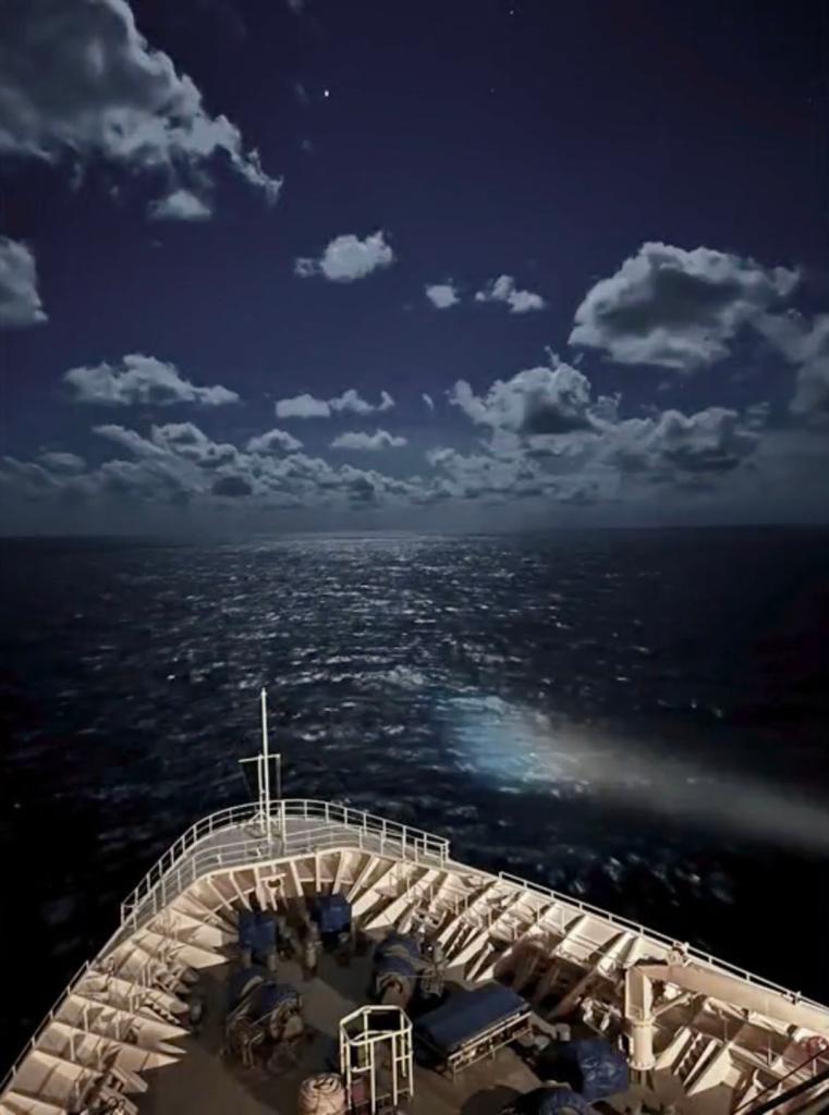 United States Coast Guard air crews conducting a search on the ocean near a cruise ship deck after a man went overboard