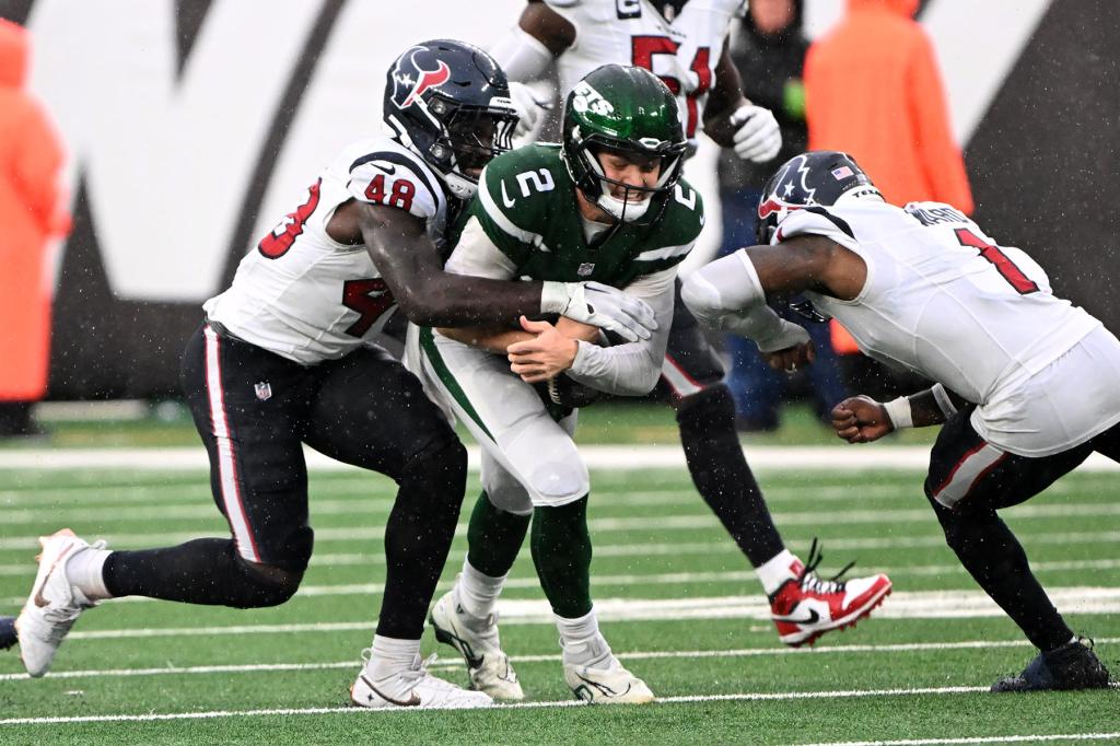 Jets quarterback Zach Wilson (2) is tackles by Houston Texans linebacker Christian Harris (48) during the third quarter against the Houston Texans in East Rutherford, NJ. 