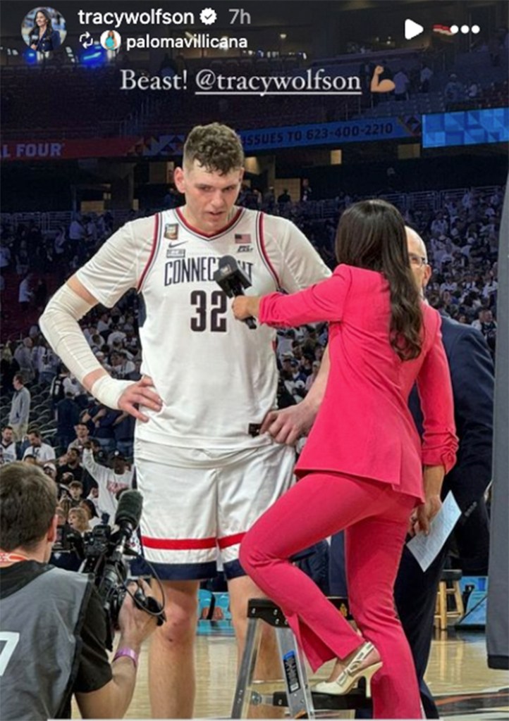 Tracy Wolfson (right) speaks to UConn's Donovan Clingan (left) and head coach Dan Hurley (center) following the Huskies' Final Four win on April 6, 2024.