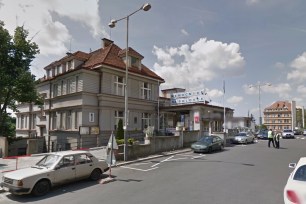 Exterior view of Bulovka University Hospital, Prague with cars parked along the street