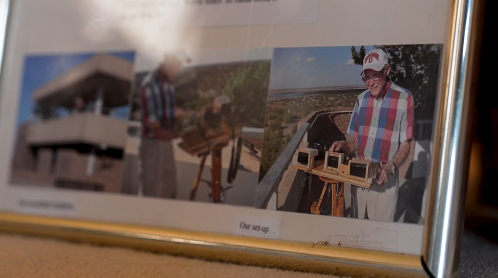 Framed photo of LaVerne Biser with his homemade telescopes 