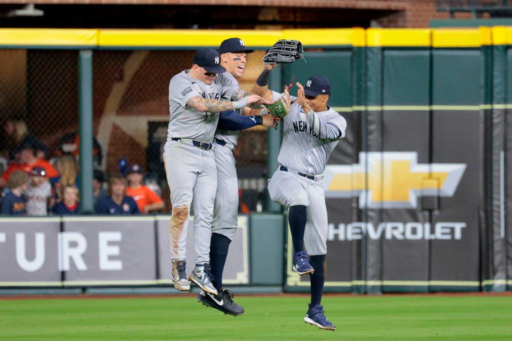 Alex Verdugo #24 of the New York Yankees along with Aaron Judge #99 and Juan Soto #22 celebrate after the final out of the 9th inning. The New York Yankees defeat the Houston Astros 7-1