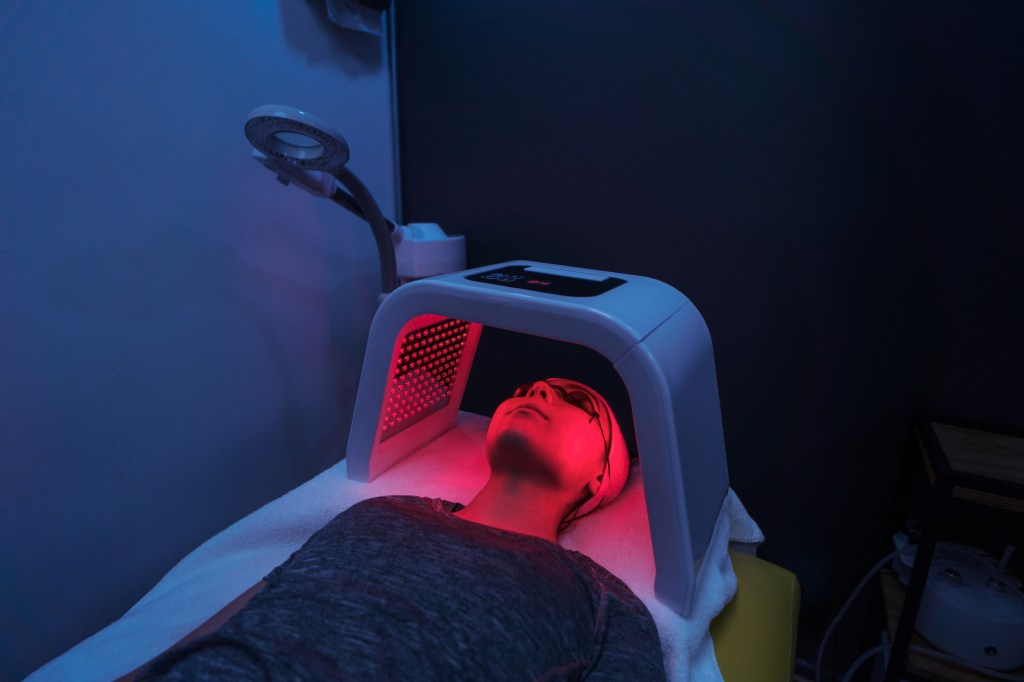 Person under a red light therapy treatment