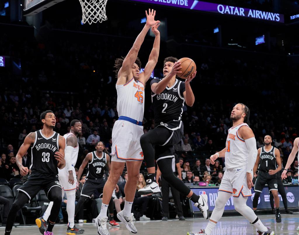 Cameron Johnson #2 of the Brooklyn Nets goes up for a shot as Jericho Sims #45 of the New York Knicks defends during the first period