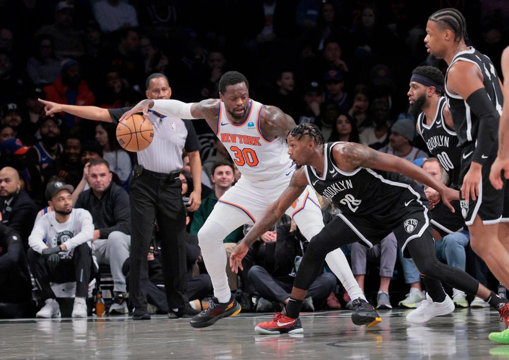 Dorian Finney-Smith #28 of the Brooklyn Nets tries to steal the ball from Julius Randle #30 of the New York Knicks during the first period. 