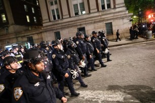 NYPD officers in riot gear march onto Columbia University campus, where anti-Israel students were barricaded inside a building and set up an encampment.