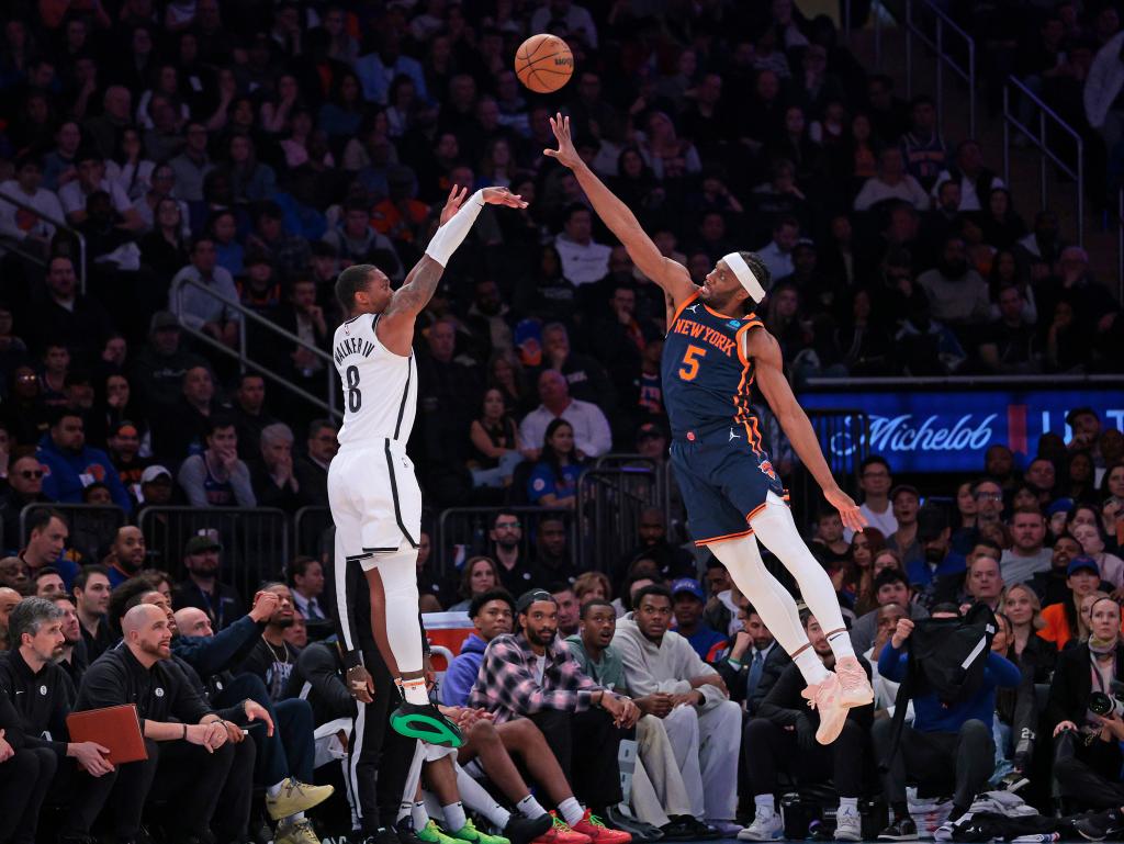 Brooklyn Nets guard Lonnie Walker IV #8 puts up a shot as New York Knicks forward Precious Achiuwa #5 jumps to defend during the second quarter. 