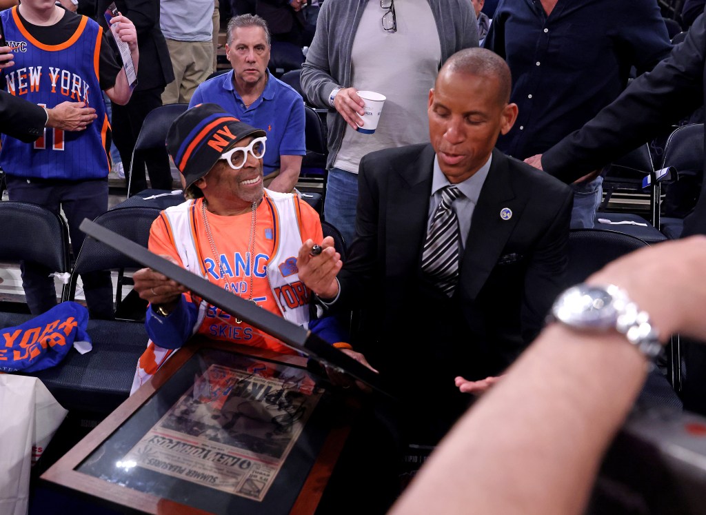 Indiana Pacers vs. New York Knicks at Madison Square garden - Indiana Pacers great Reggie Miller autographs two framed newspapers for Spike Lee one of them is a New York Post before the start of tonightâs game.