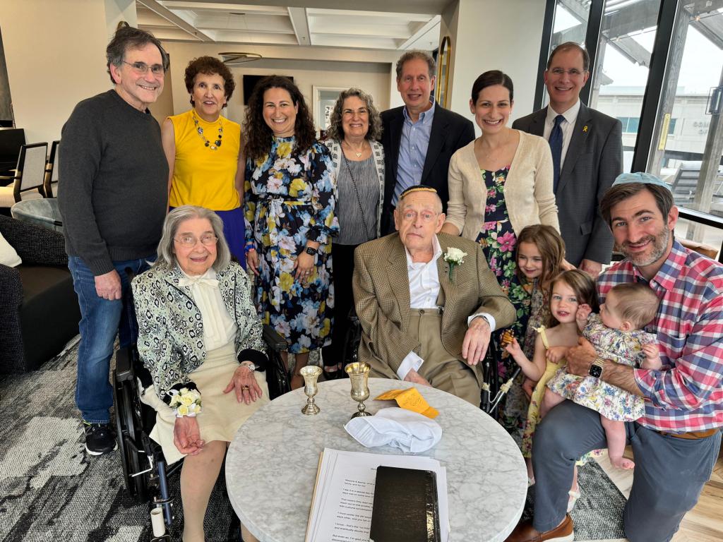 Four generations of the Littman family gathered to celebrate the wedding of Bernie Littman (seated in center, with white flower on his lapel) and Marjorie Fiterman (seated, far left, with flowers on her right wrist). 