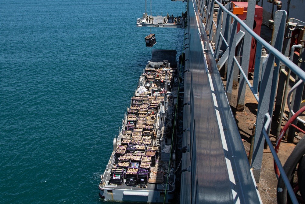 Humanitarian aid is lifted by a crane operated by Soldiers assigned to the 7th Transportation Brigade (Expeditionary) from a Navy causeway at the Port of Ashdod, Israel. 