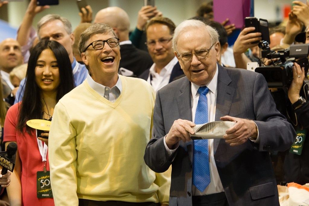 Warren Buffett and Bill Gates discussing newspaper tossing skills at the 2015 Berkshire Hathaway Annual Shareholders Meeting in Omaha, Nebraska