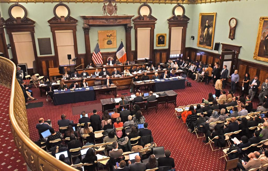 New York City Council holding a hearing with people in seats. 
