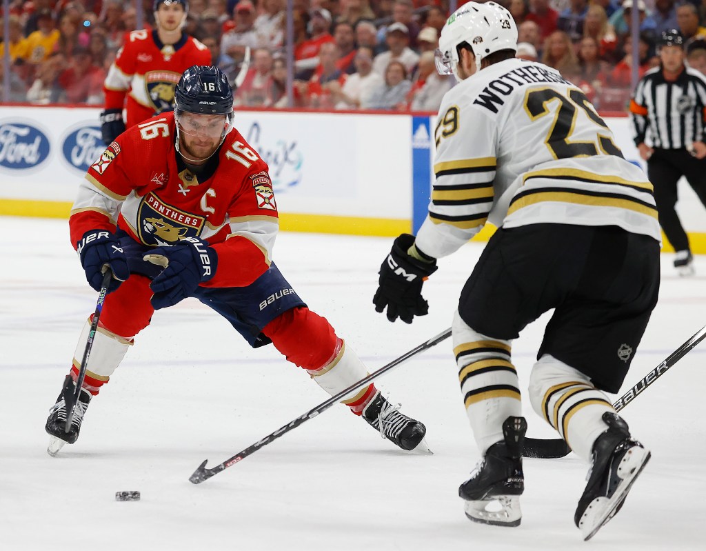 Aleksander Barkov #16 of the Florida Panthers skates for possession against Parker Wotherspoon #29 of the Boston Bruins