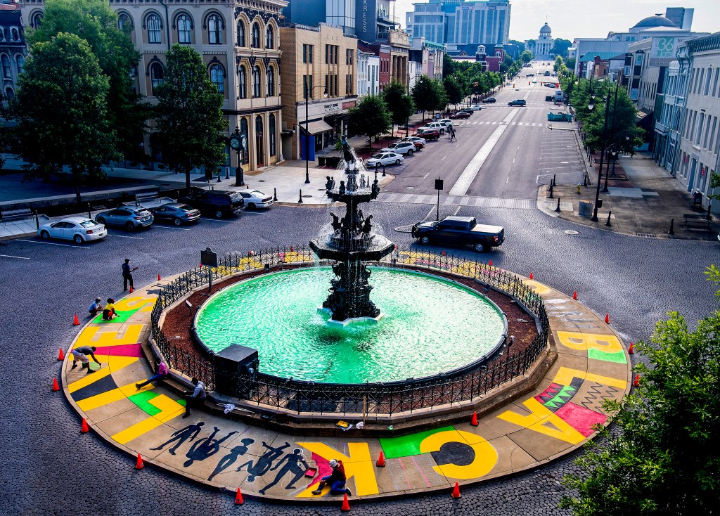 Volunteers finish painting the Black Lives Matter mural around Court Square Fountain